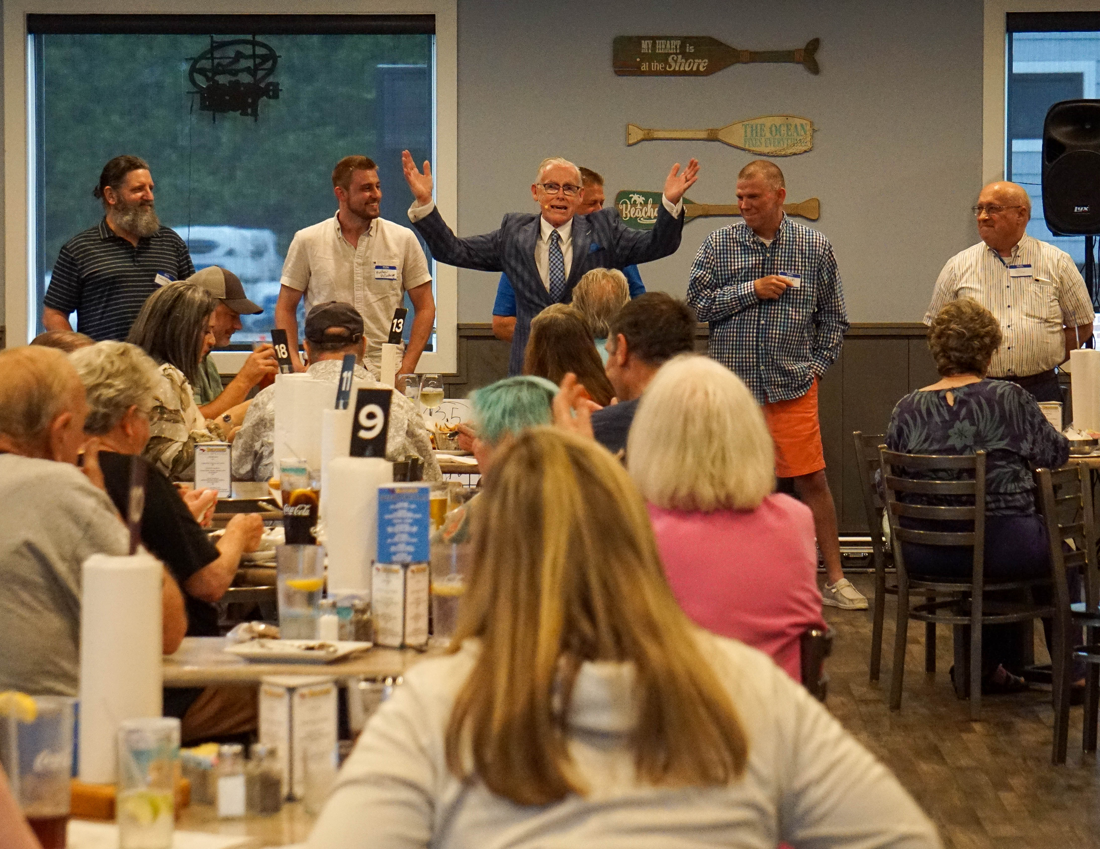 Dan Gaffney performing a live mind reading magic show for a packed restaurant audience